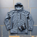 Lightweight waterproof hooded windbreaker hiking jacket laid flat with pouch